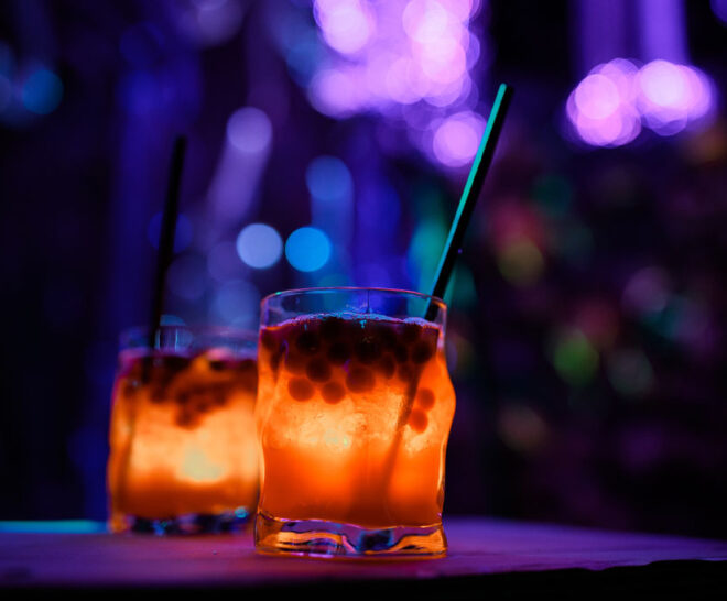 Close-up of themed space cocktails inside Avora’s futuristic cocktail environment.
